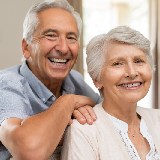 Middle aged couple smiling happily after full mouth restoration with all-on-4 dental implants  in Vietnam with Glamjet. Glamjet works with the best dentists in Hanoi and Ho Chi Minh city in Vietnam