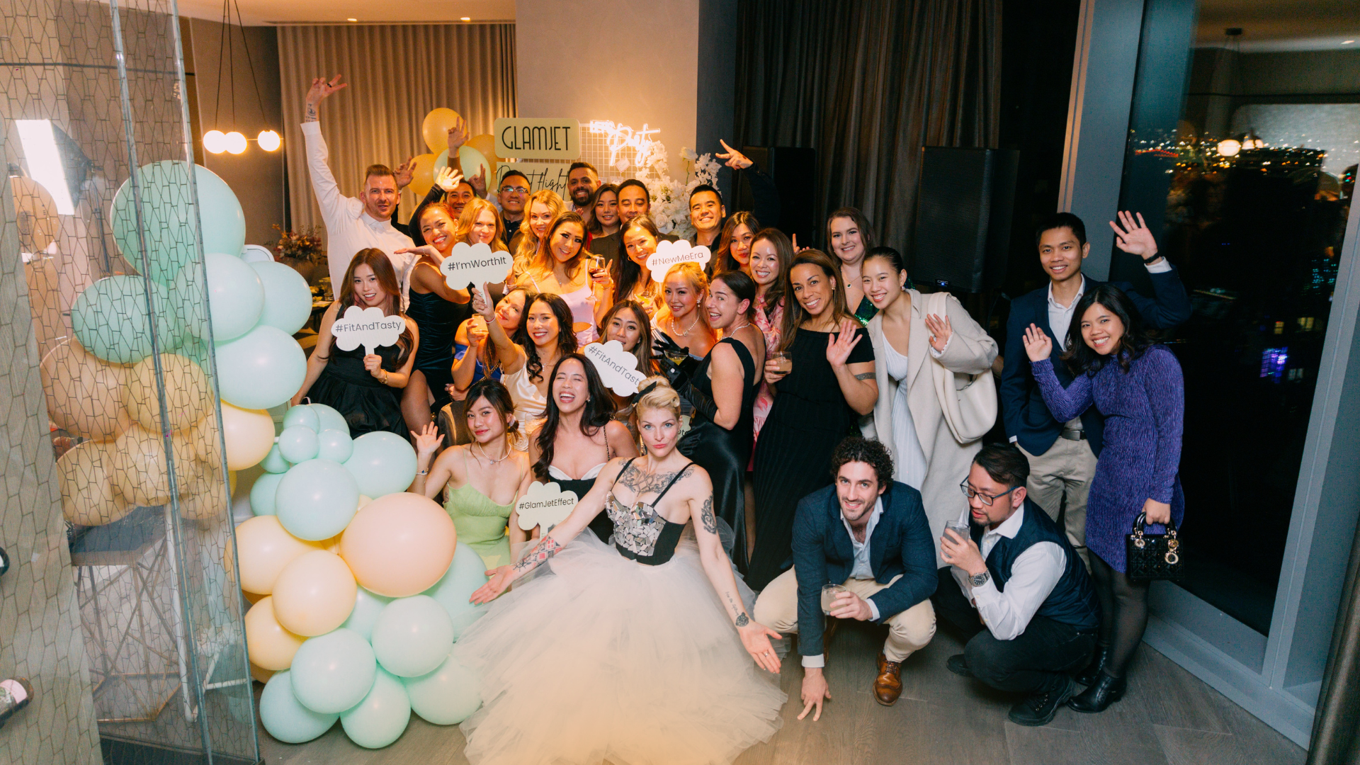 Group of clients and partners of glamjet.com.au which is a leading global beauty and medical tourism booking platform posing for a photo in a decorated room with premium catering and luxury decoration. 