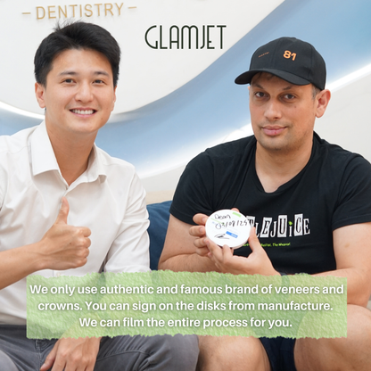 Two men sitting next to each other at a dental clinic in Ho Chi Minh city. An Australian client holds a disk of zirconia with his name and signature on it. With glamjet.com.au , Australian clients can feel confident that they get dental treatments with world class products and quality in Vietnam. Cheaper doesn't mean lesser quality. 